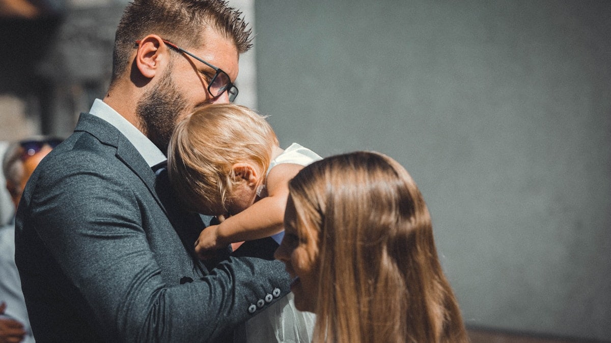 a man in a suit holding a small child